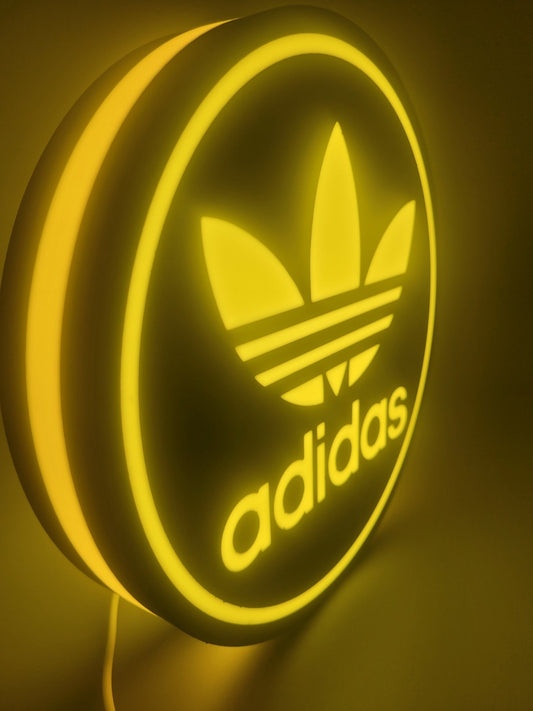 adidas LED light sign with illuminated logo viewed from side view