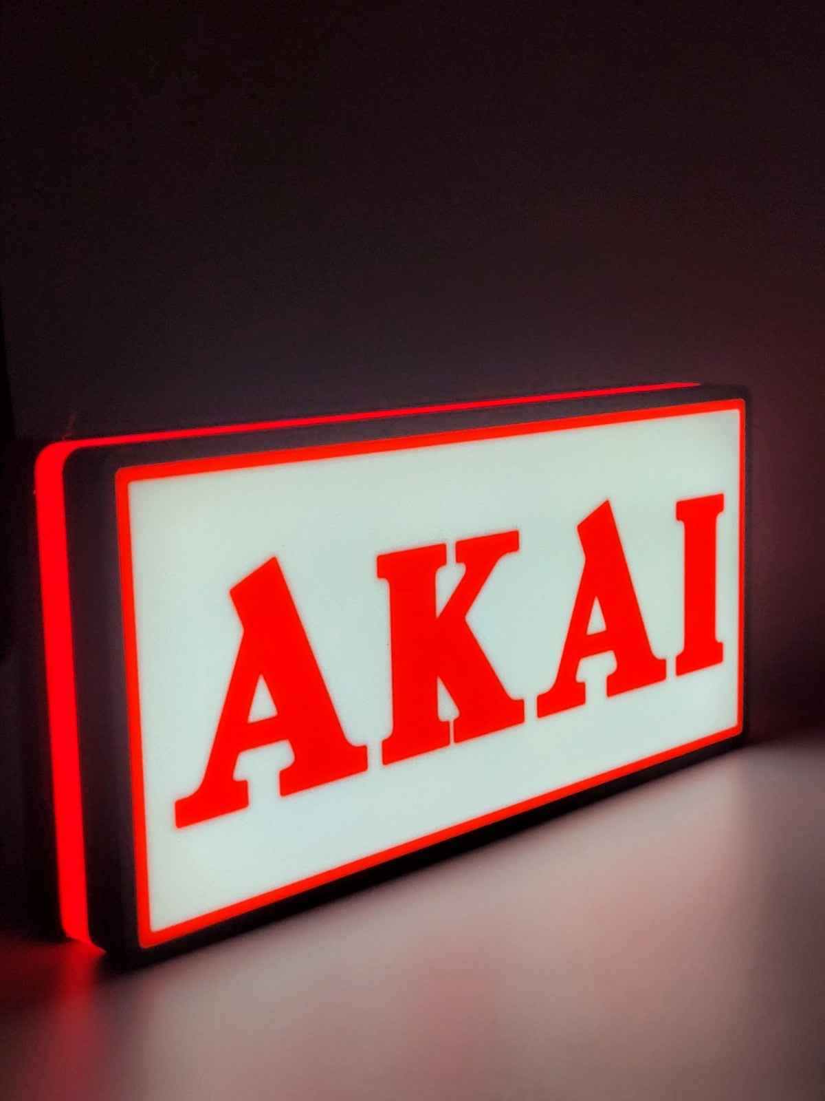 Akai led light sign with illuminated logo viewed from side view