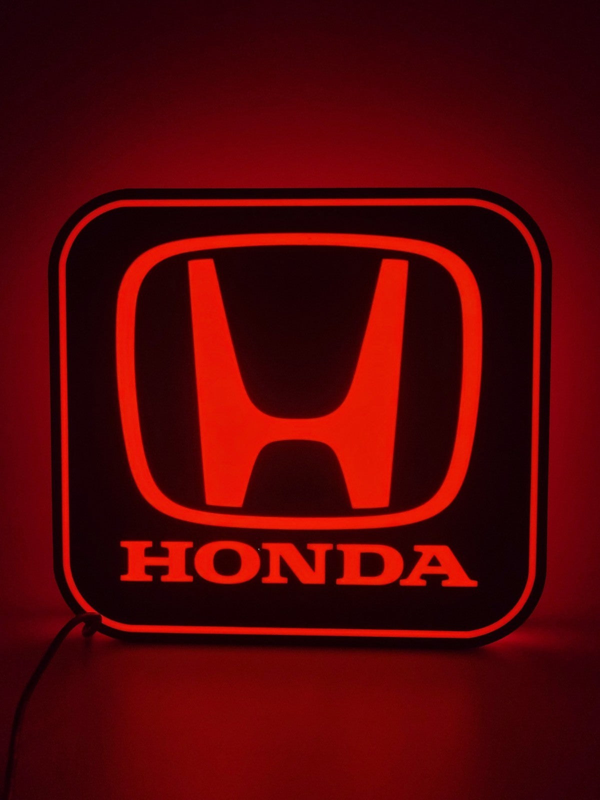 Honda LED light sign with illuminated logo viewed from straight on