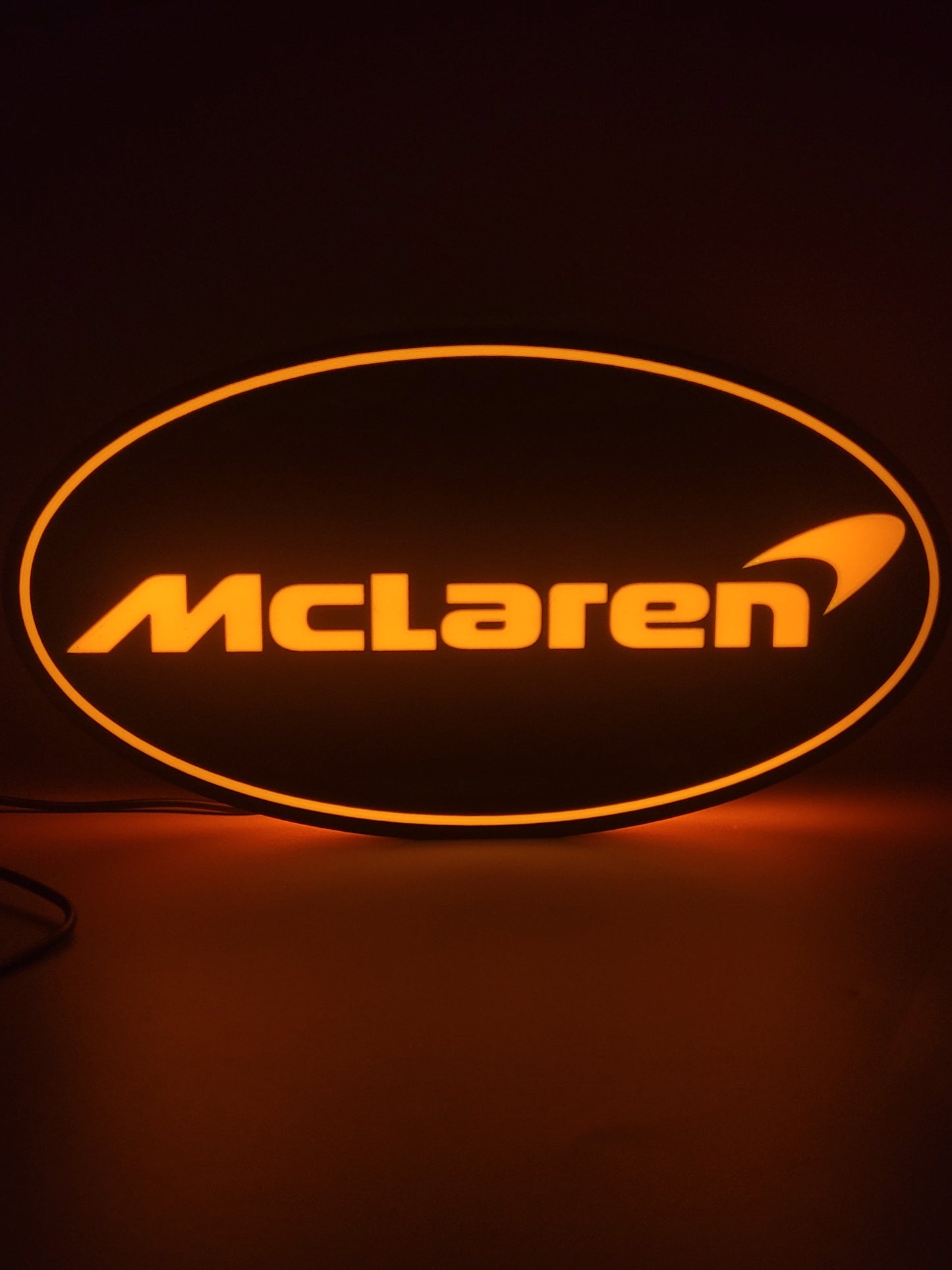Mclaren LED light sign with illuminated logo viewed from straight on