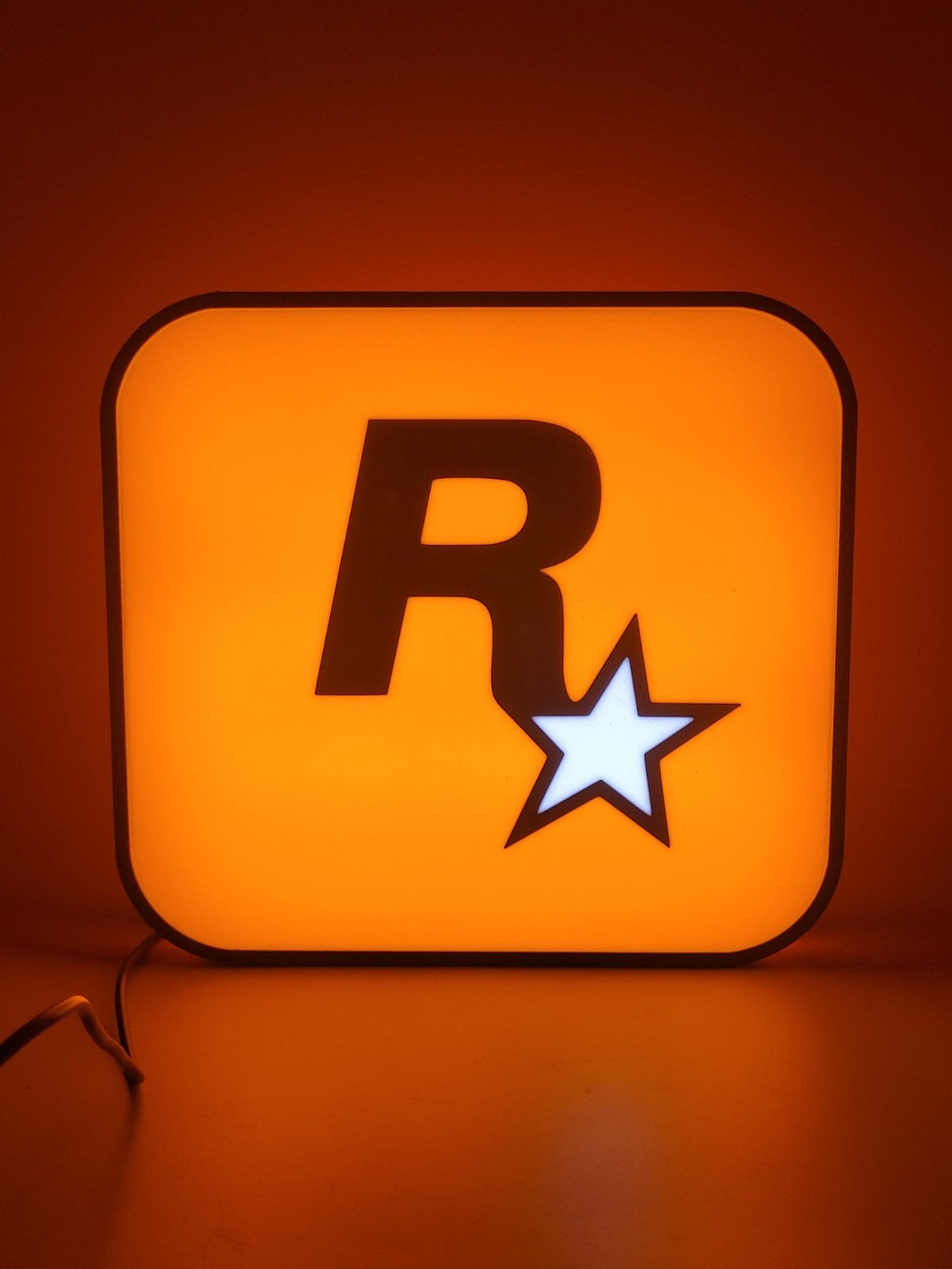 Rockstar LED light sign with illuminated logo viewed from straight on