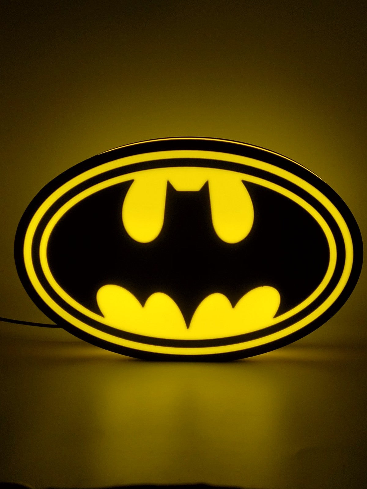 Batman led light sign with illuminated logo viewed from straight on