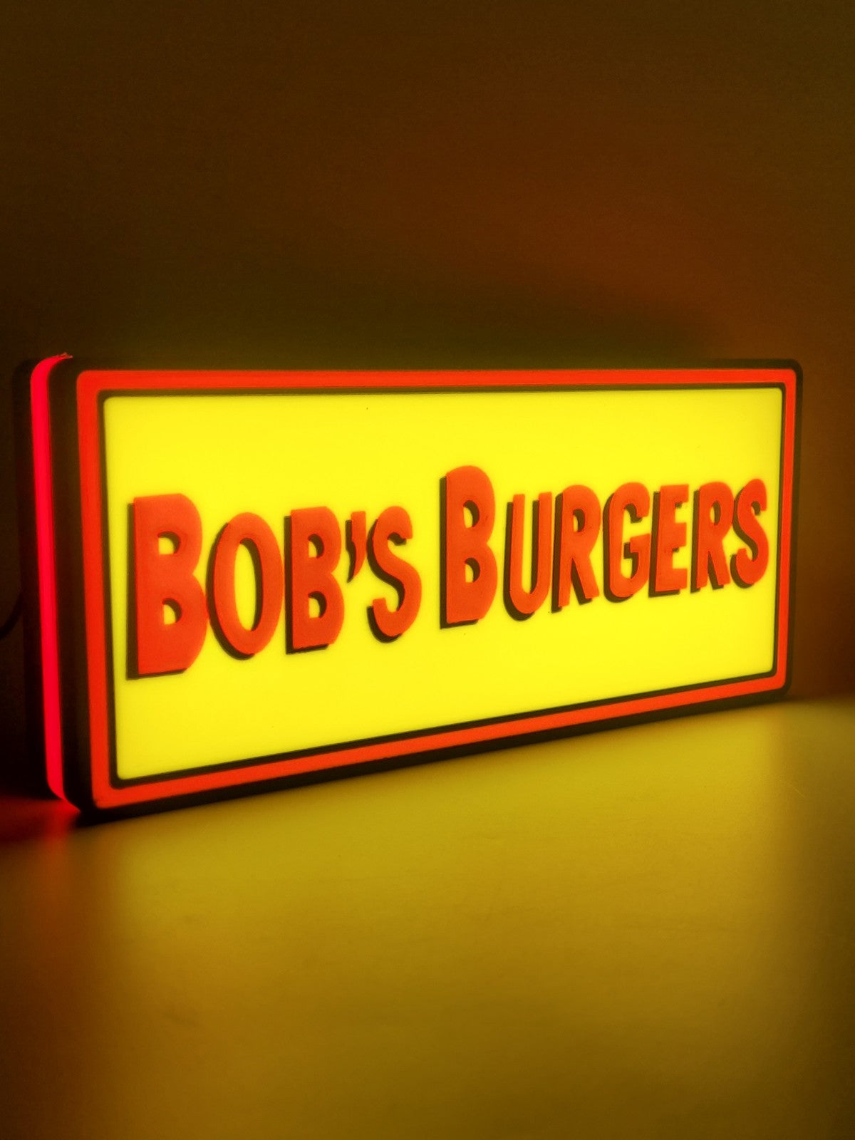bob's burgers led light sign with illuminated logo viewed from side view