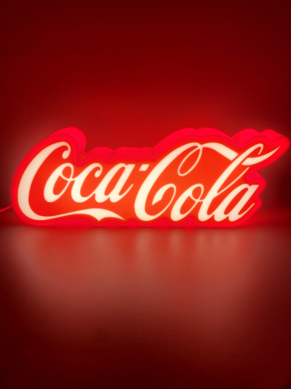 coca-cola led light sign with illuminated logo viewed from straight on