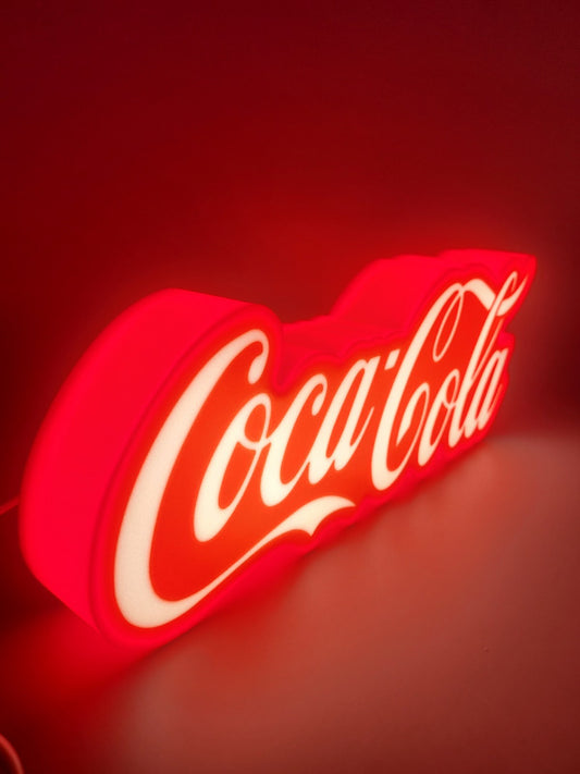 Coca-cola LED light sign with illuminated logo viewed from side view