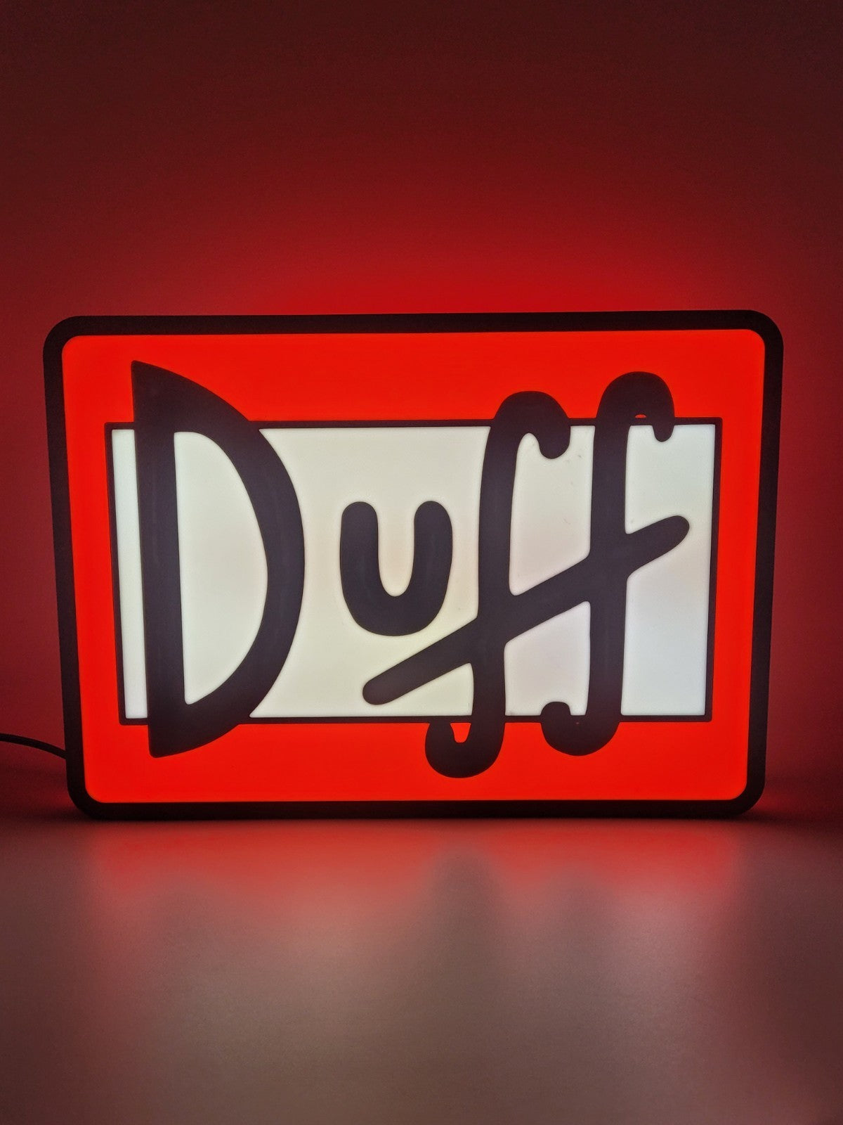 DUFF led light sign with illuminated logo viewed from straight on