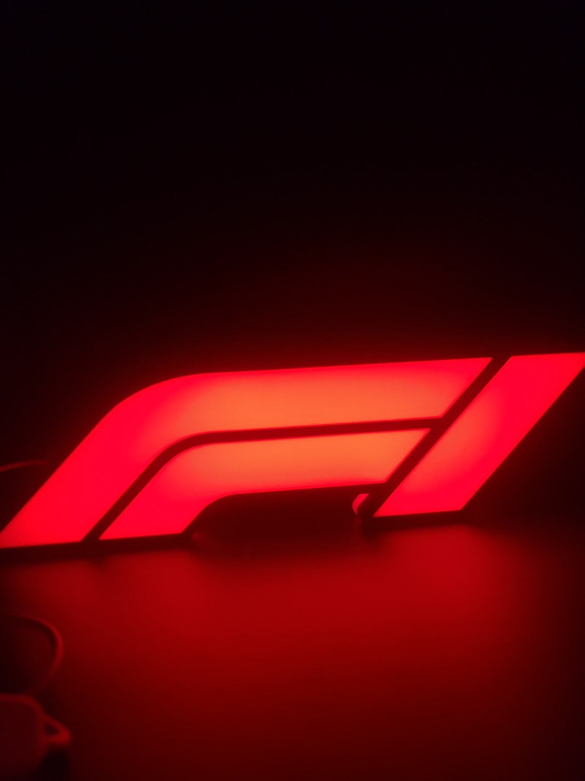 F1 led light sign with illuminated logo viewed from side view