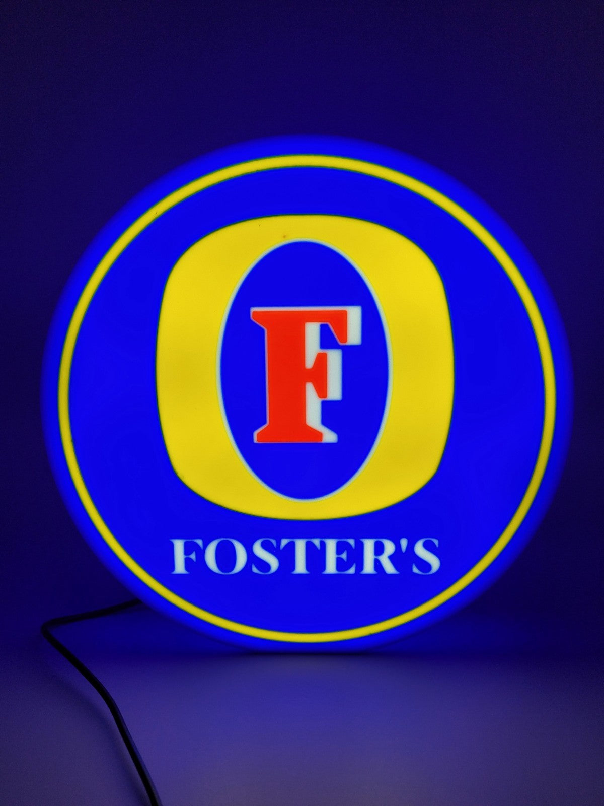 FOSTERS led light sign with illuminated logo viewed from straight on