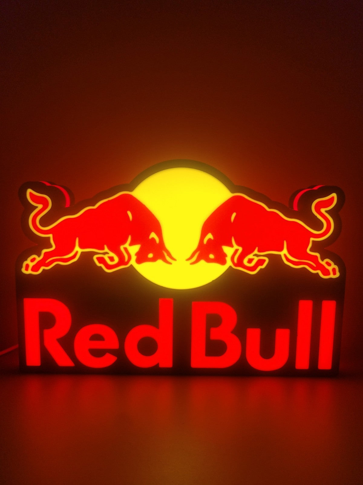 Redbull led light sign with illuminated logo viewed from straight on