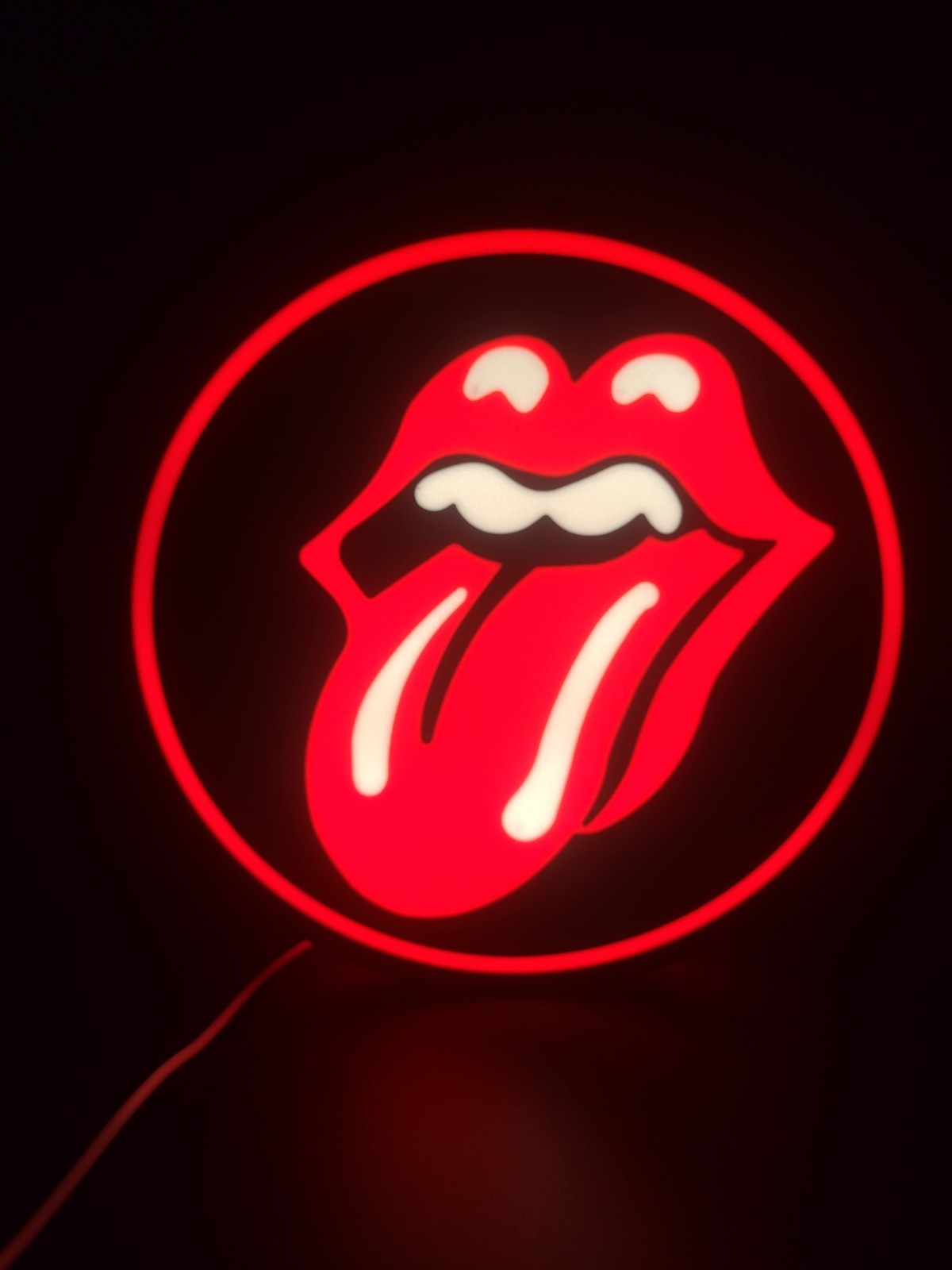 rolling stones led light sign with illuminated logo viewed from straight on