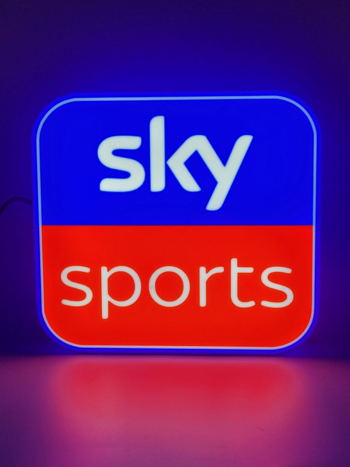 sky sports led light sign with illuminated logo viewed from straight on