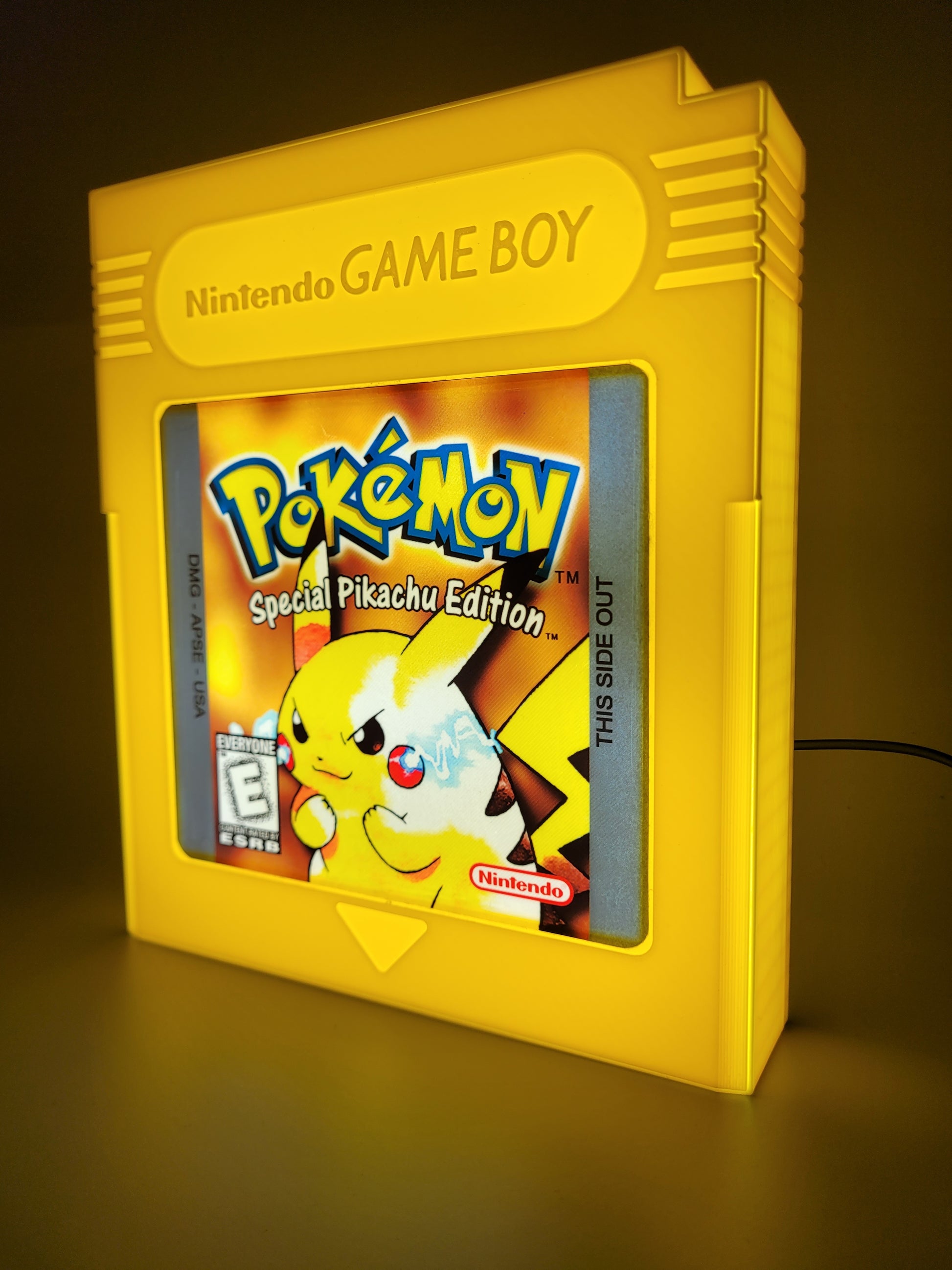 Yellow Game Boy cartridge with Pokémon Special Pikachu Edition on a dark background