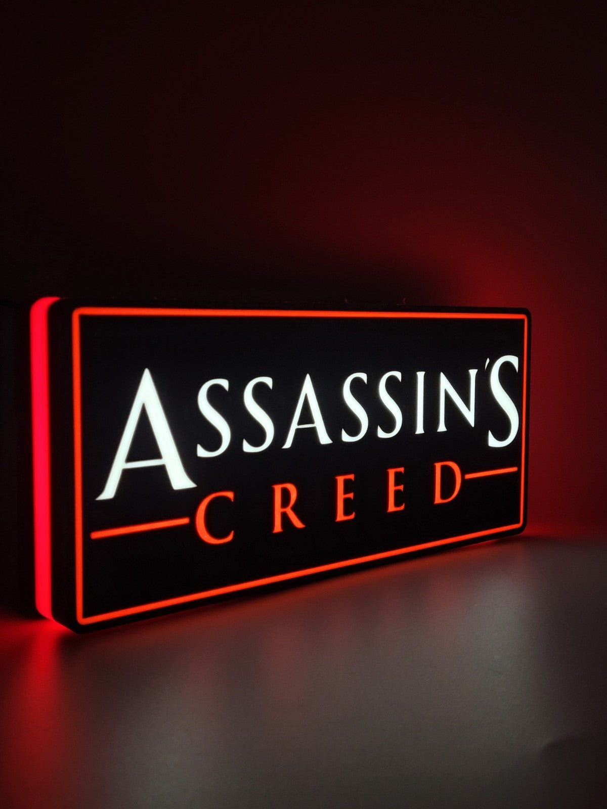 assassin's creed led light sign with illuminated logo viewed from side view