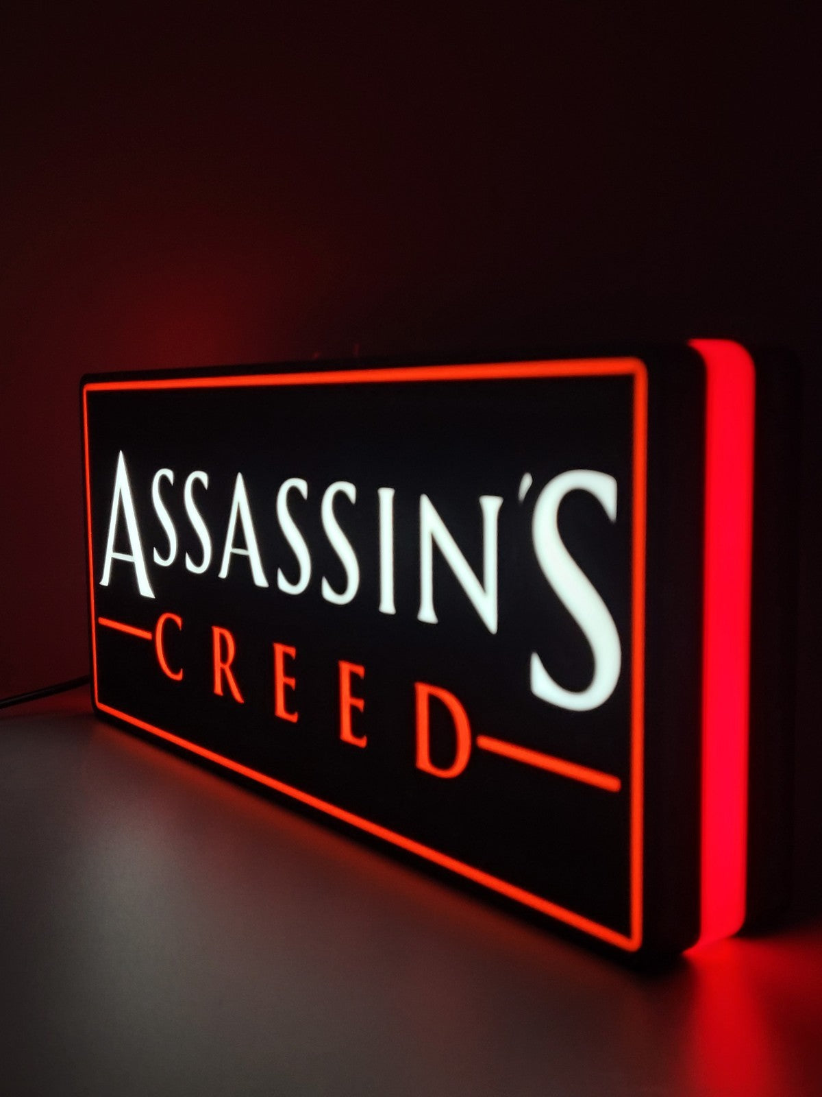 assassin's creed led light sign with illuminated logo viewed from side view