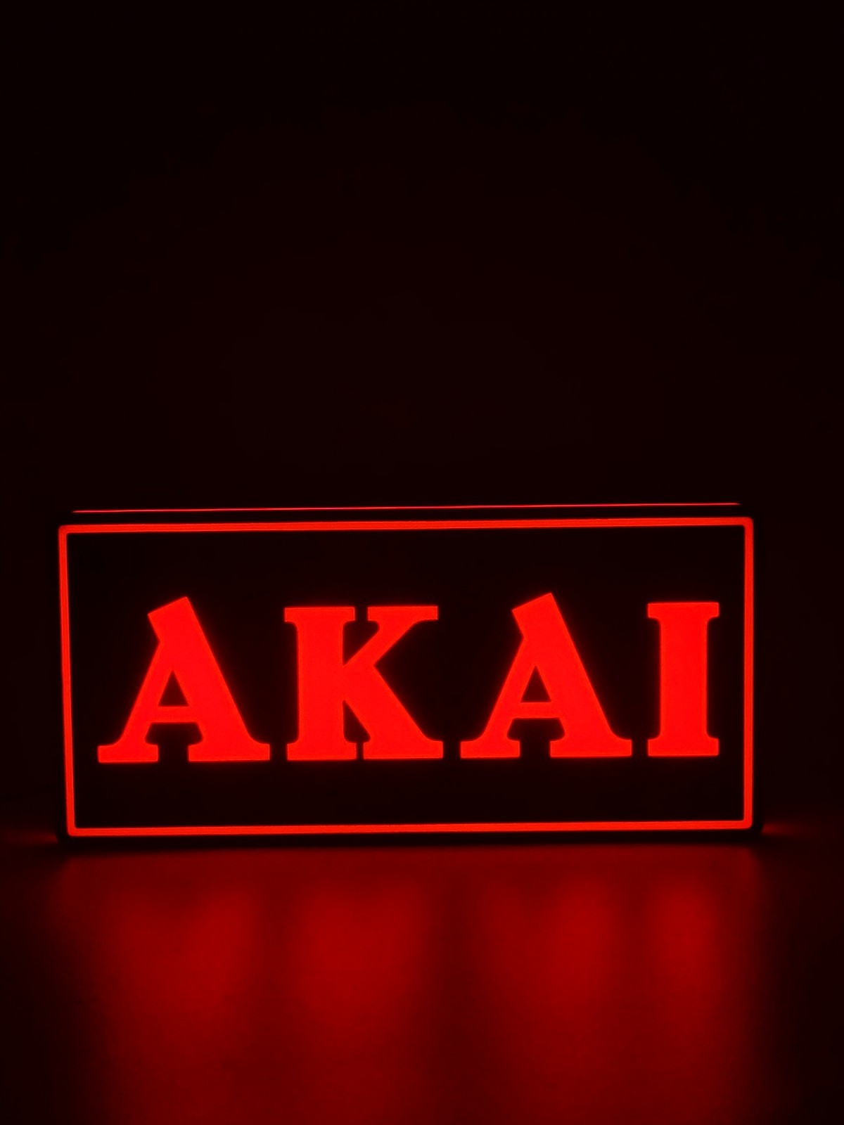 Akai led light sign with illuminated logo viewed from straight on