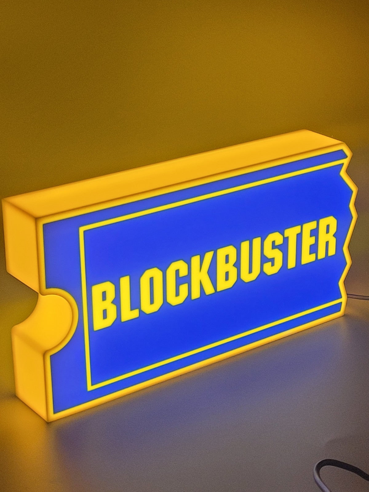 Blockbuster LED light sign with illuminated logo viewed from side view