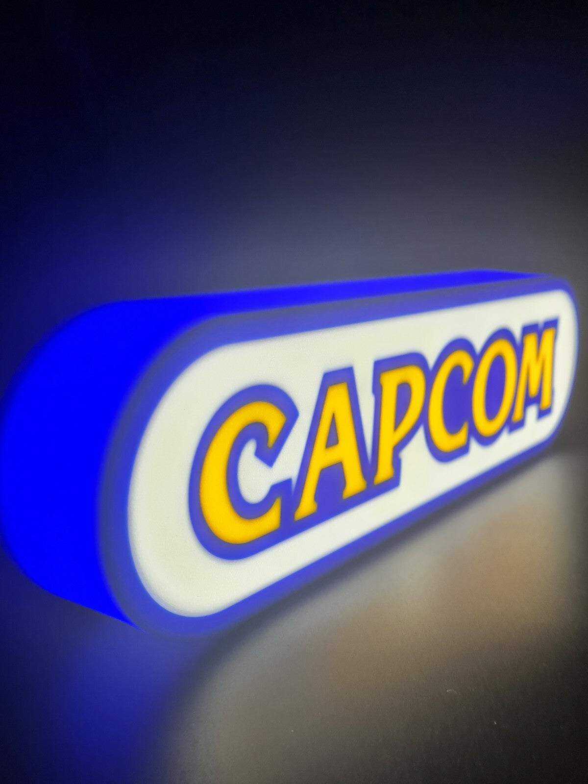 Capcom LED light sign with illuminated logo viewed from side view