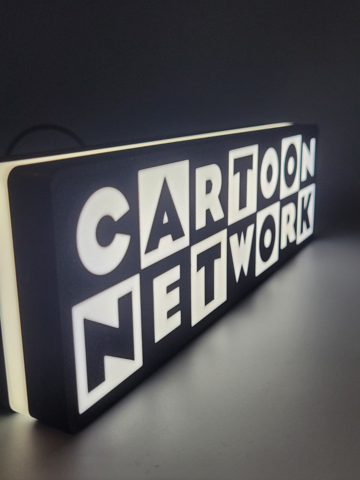 Cartoon Network LED light sign with illuminated logo viewed from side view
