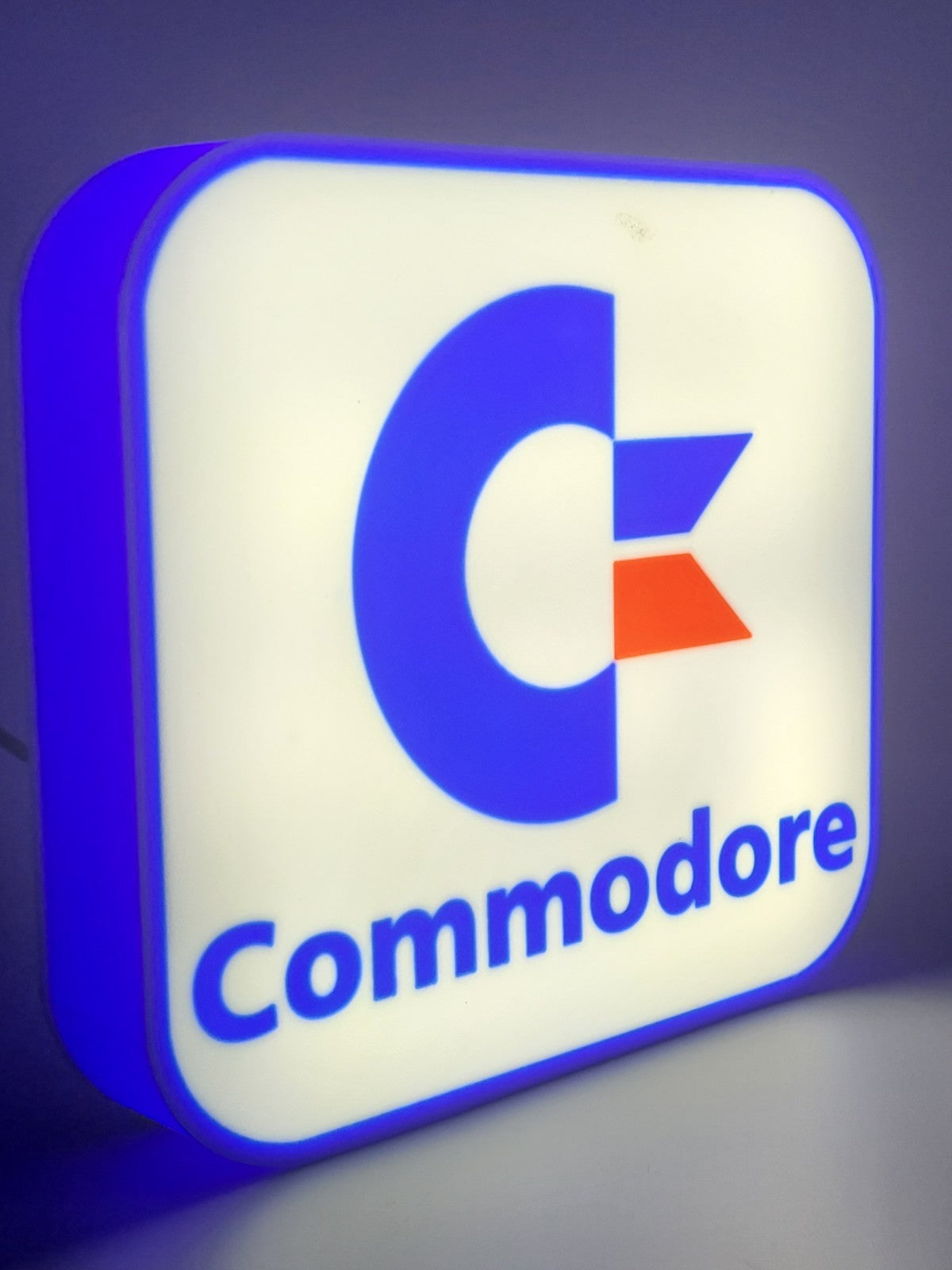 commadore led light sign with illuminated logo viewed from side view