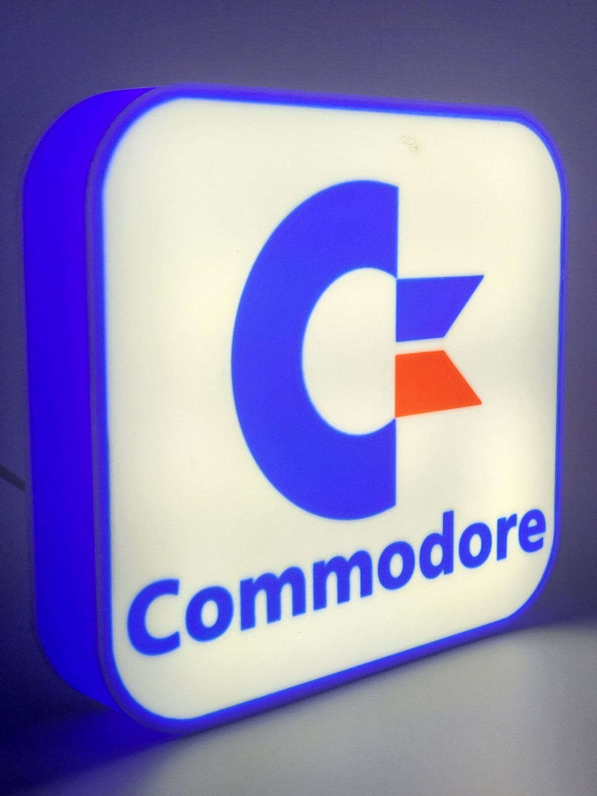 commadore led light sign with illuminated logo viewed from side view