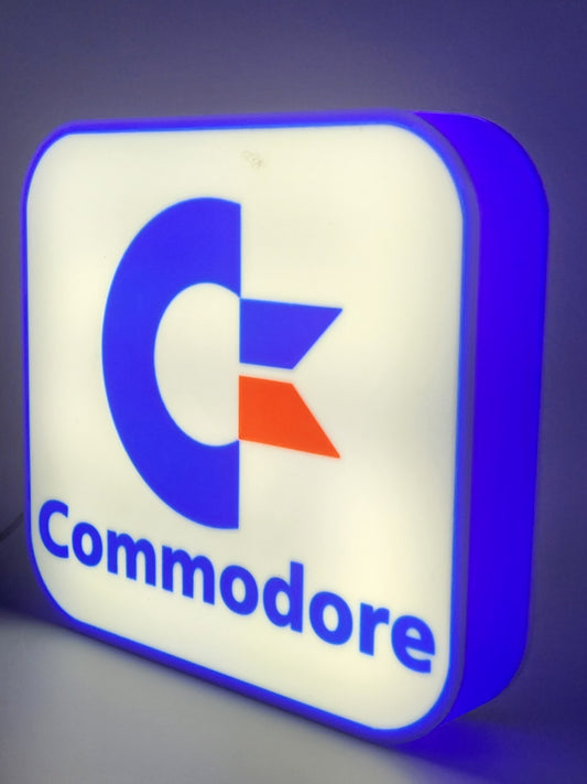 commadore led light sign with illuminated logo viewed from side view