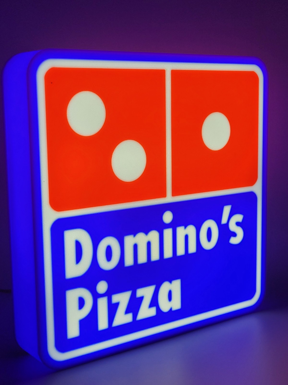 Domino's LED light sign with illuminated logo viewed from side view