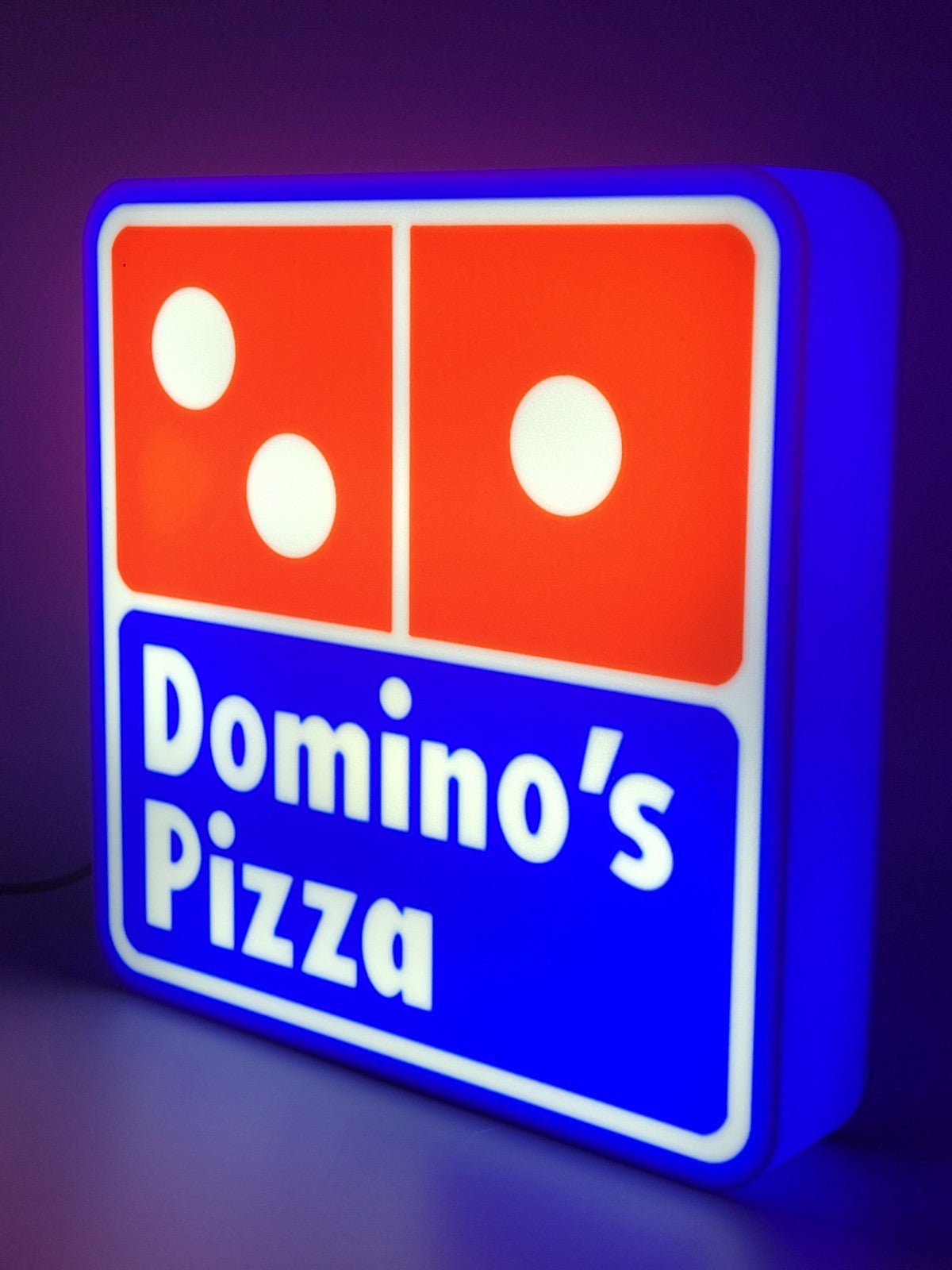 Domino's LED light sign with illuminated logo viewed from side view