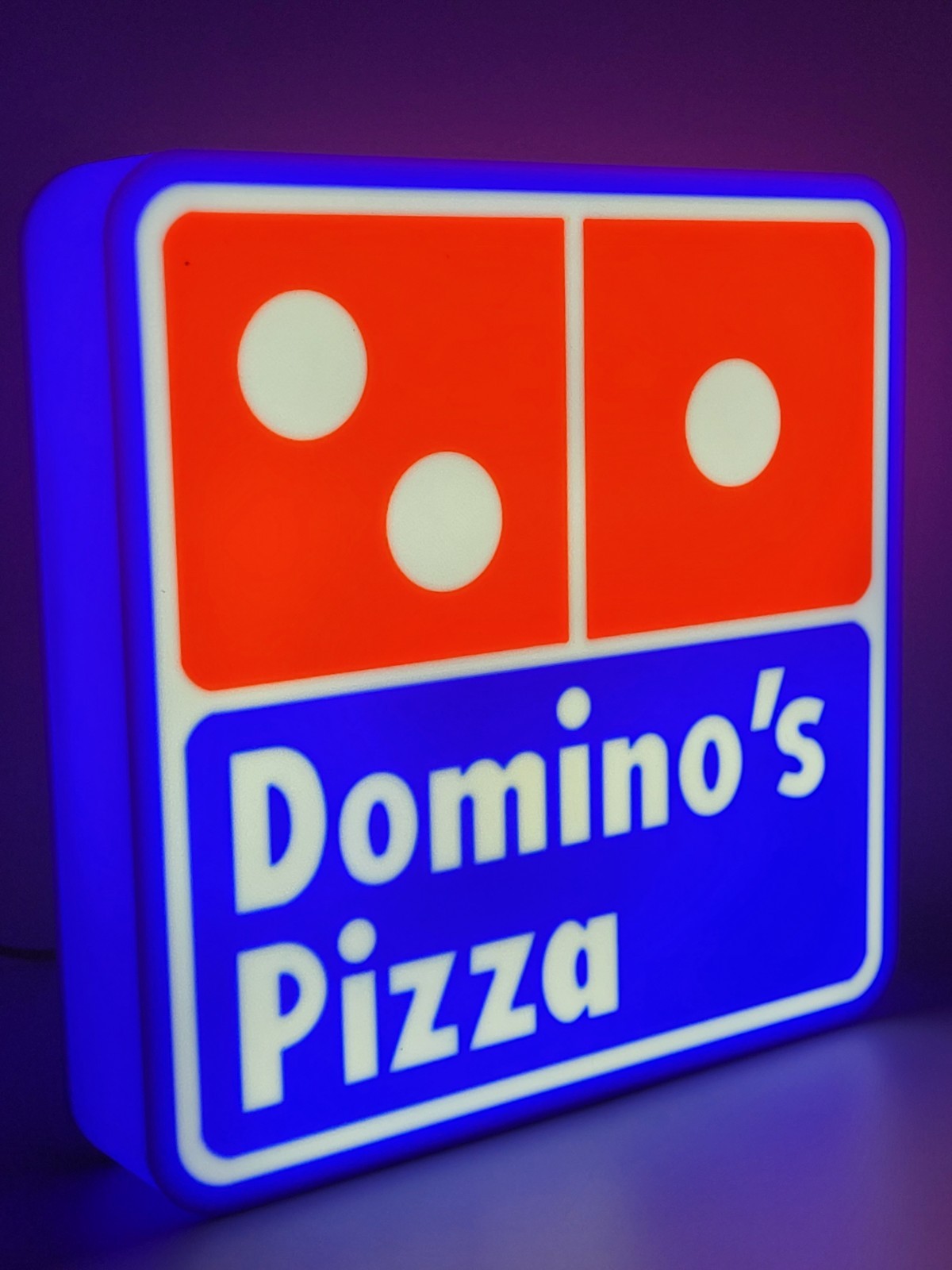 Domino's LED light sign with illuminated logo viewed from side view