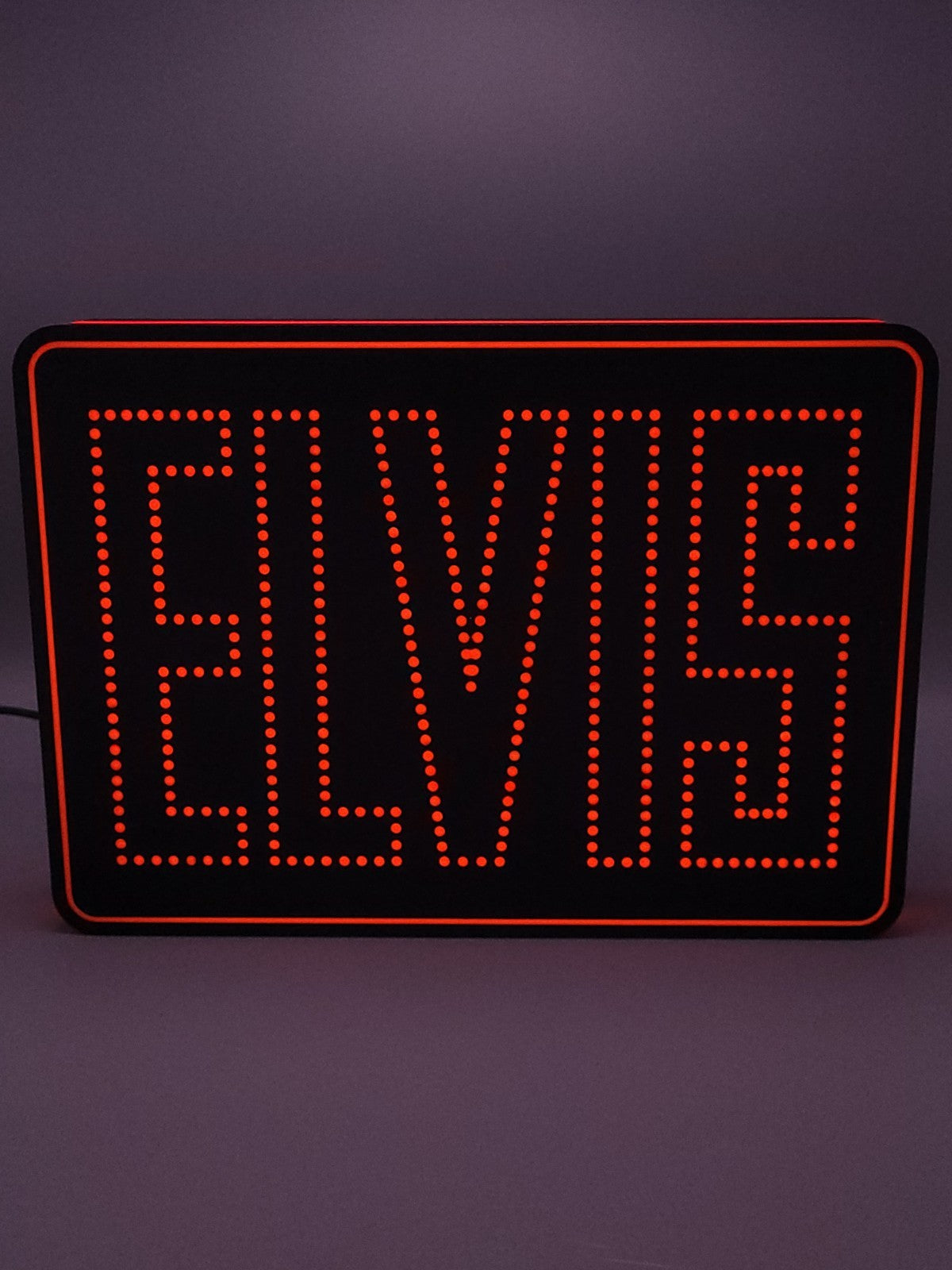 Elvis LED light sign with illuminated logo viewed from straight on
