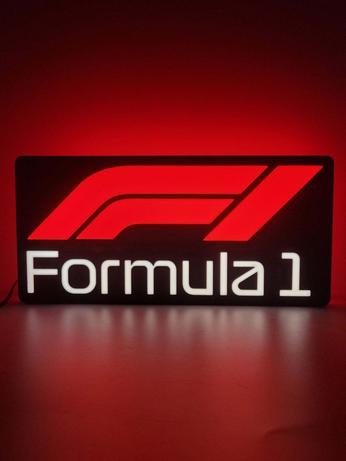 F1 LED light sign with illuminated logo viewed from straight on