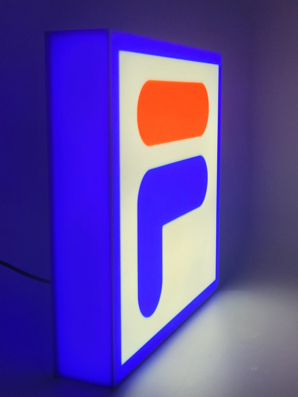 fila LED light sign with illuminated logo viewed from side view