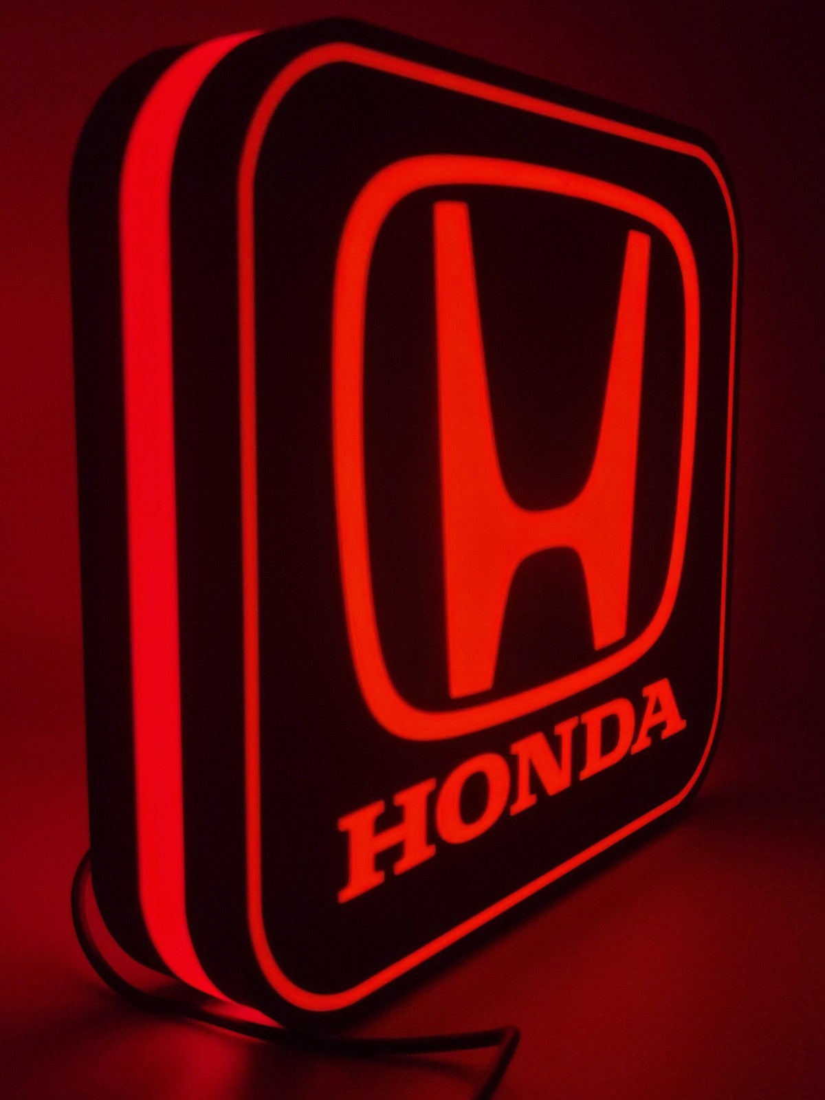 LED light sign with illuminated logo viewed from side view