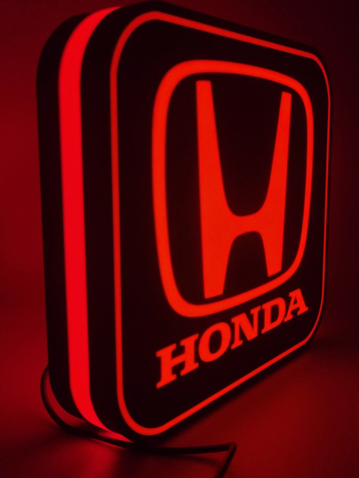Honda LED light sign with illuminated logo viewed from side view