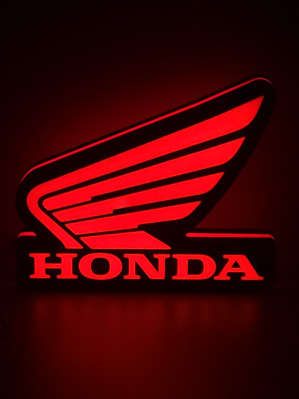 Honda Wing LED light sign with illuminated logo viewed from straight on