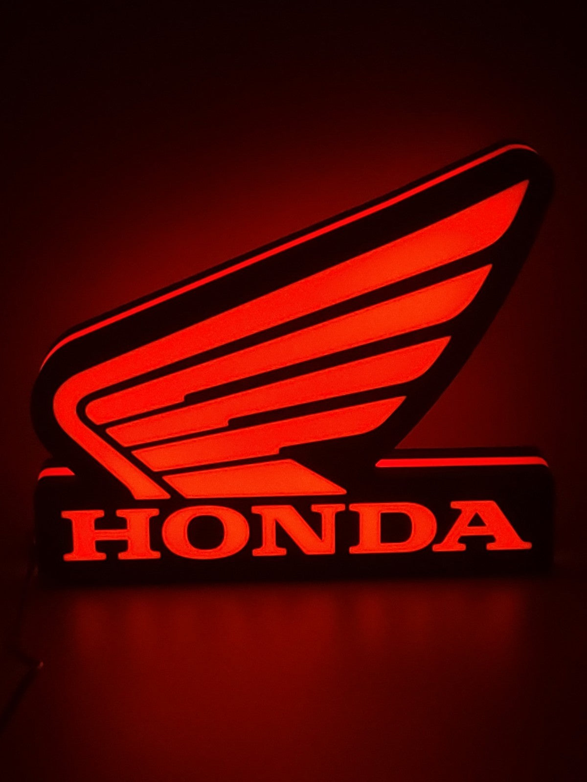 Honda Wing LED light sign with illuminated logo viewed from straight on