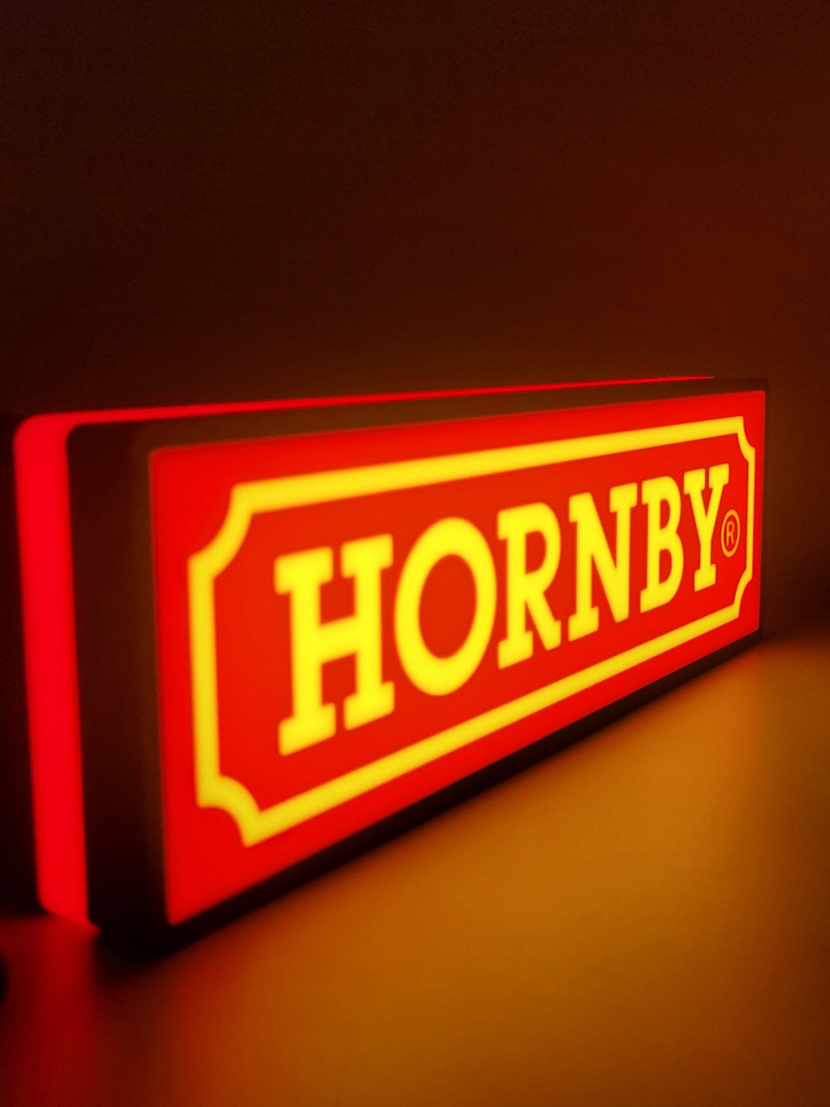 Hornby LED light sign with illuminated logo viewed from side view