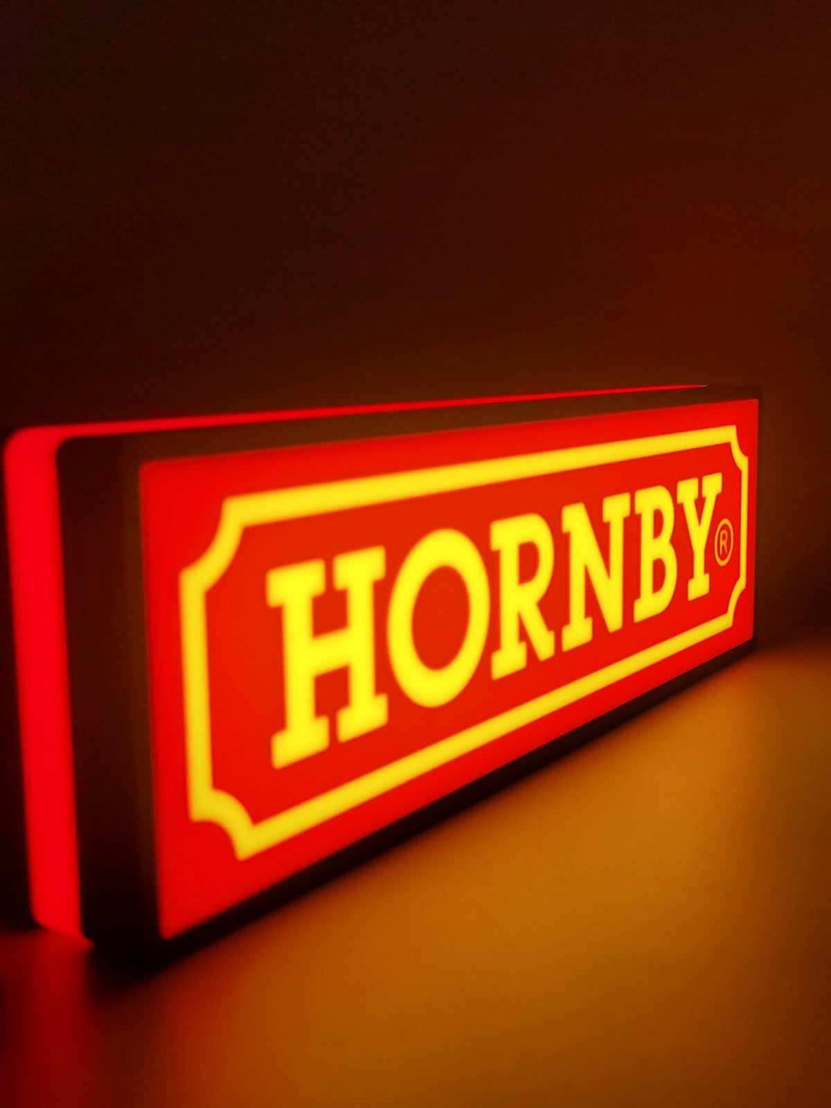 Hornby LED light sign with illuminated logo viewed from side view