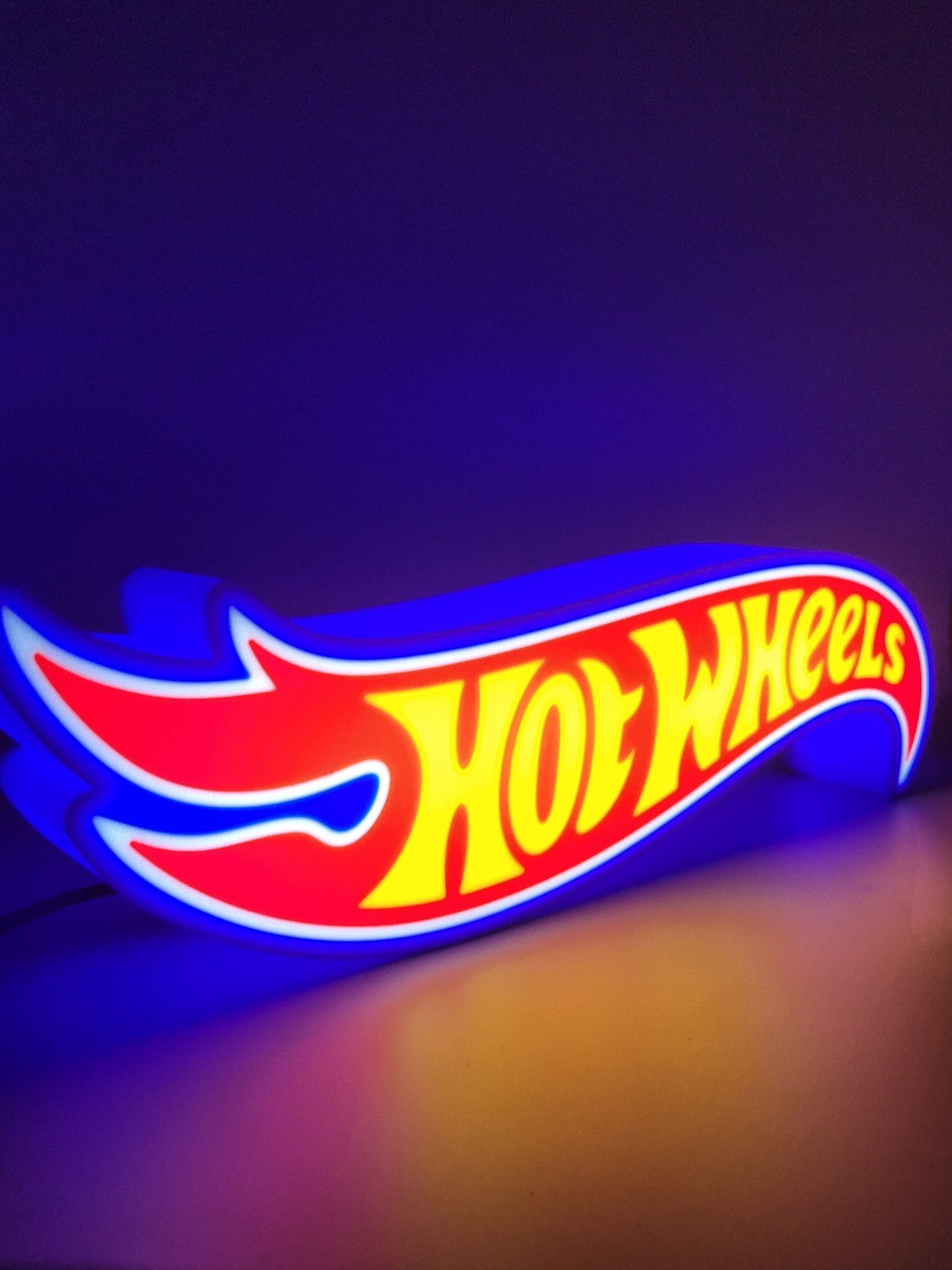 Hotwheels LED light sign with illuminated logo viewed from side view