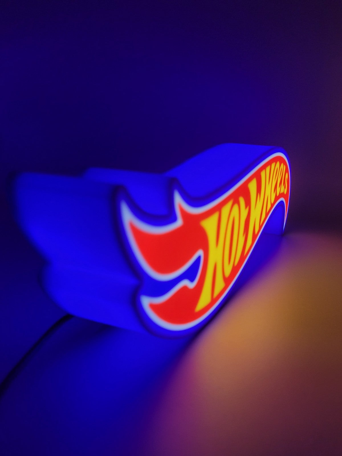 Hotwheels LED light sign with illuminated logo viewed from side view