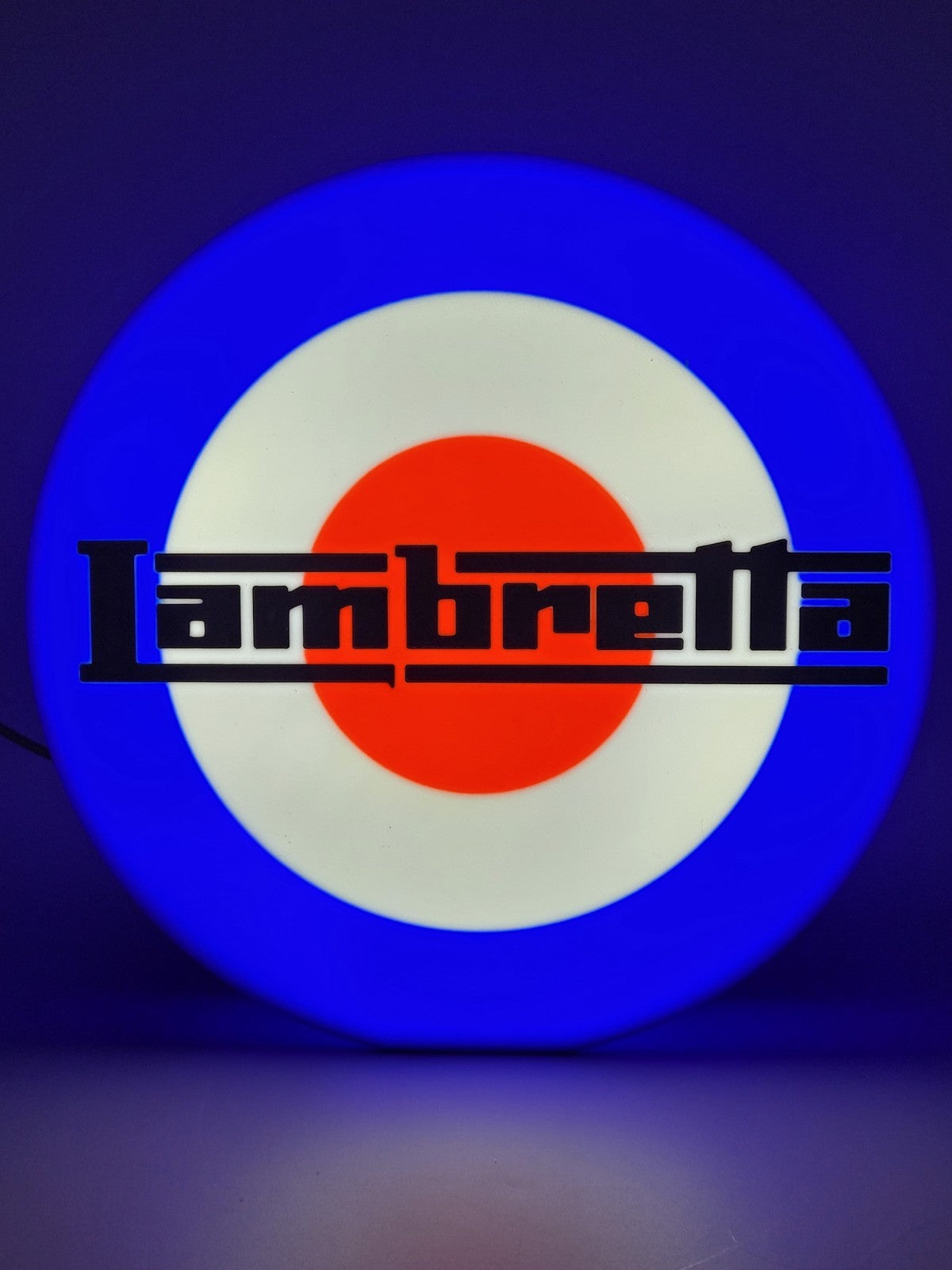 Lambretta LED light sign with illuminated logo viewed from straight on