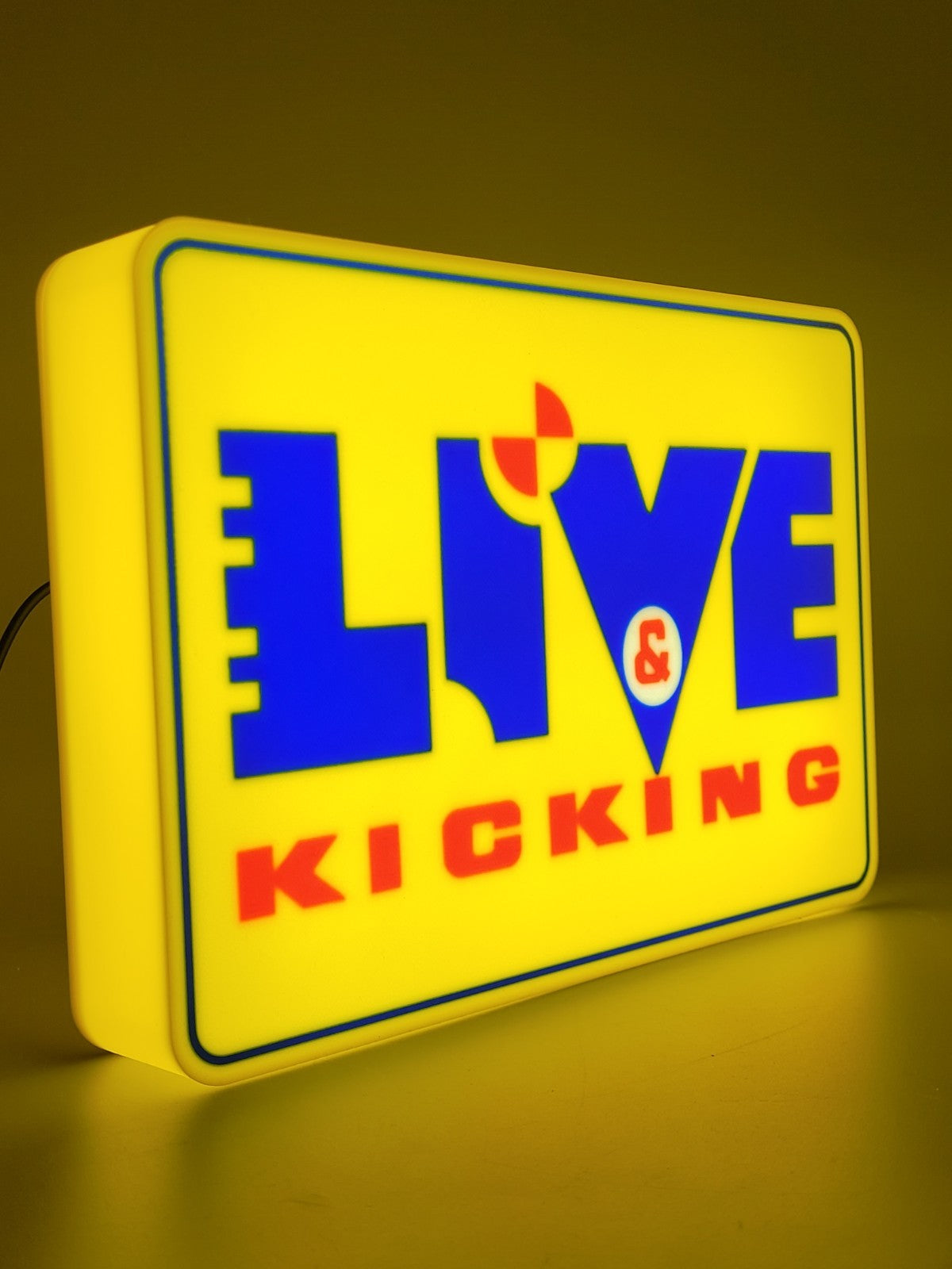 live and kicking led light sign with illuminated logo viewed from side view