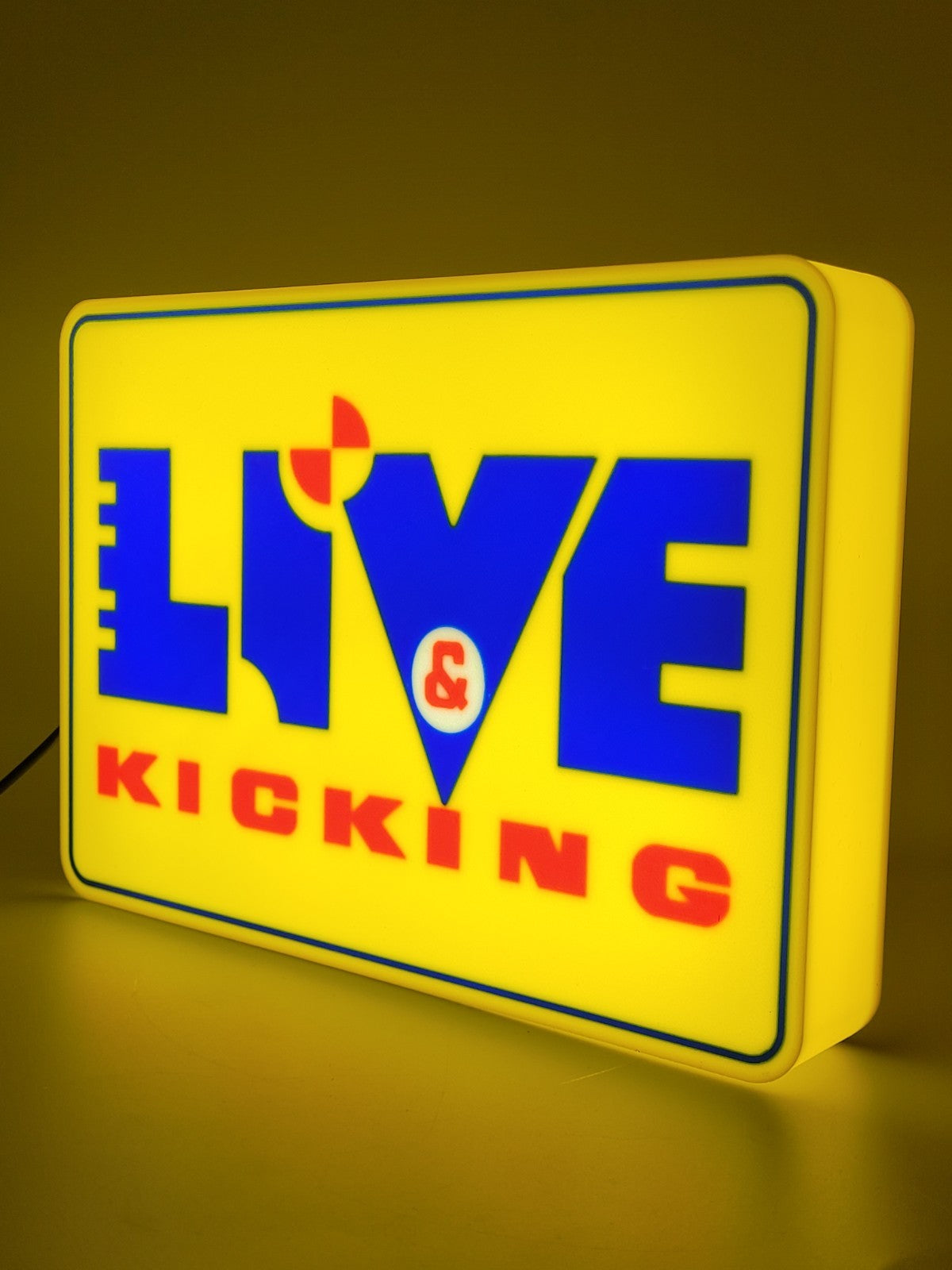 live and kicking led light sign with illuminated logo viewed from side view