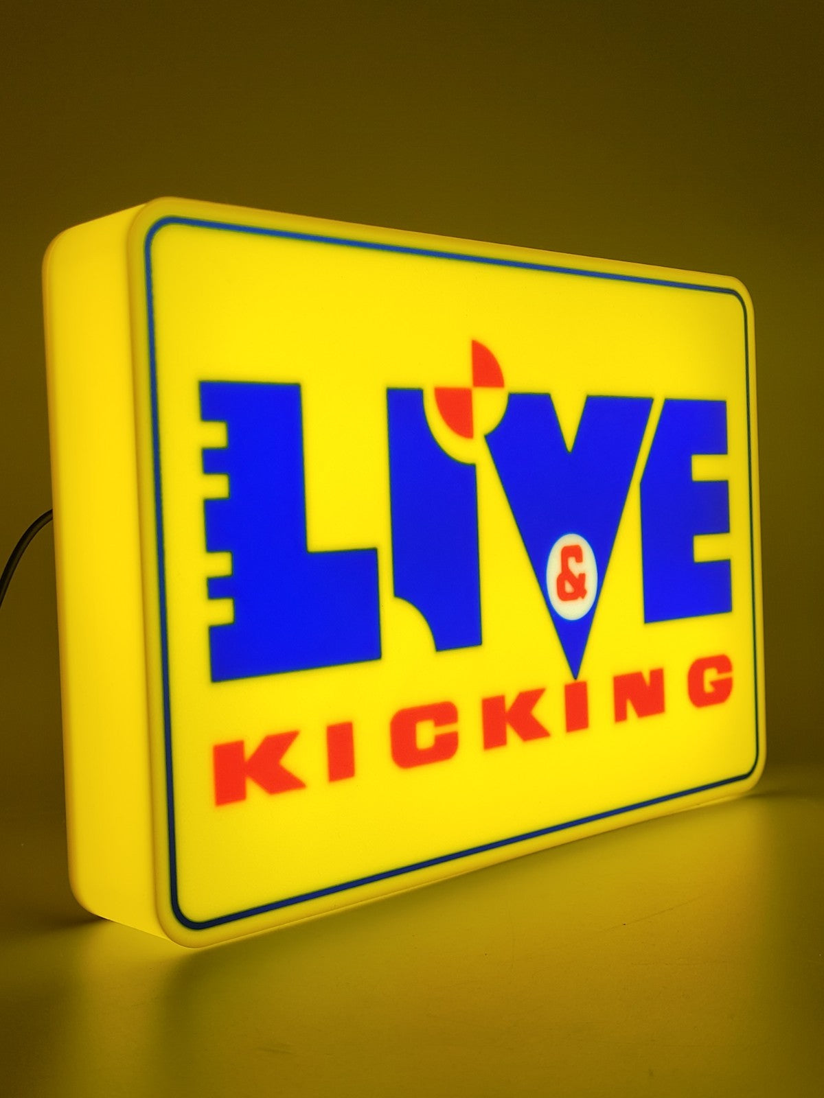 live and kicking led light sign with illuminated logo viewed from side view
