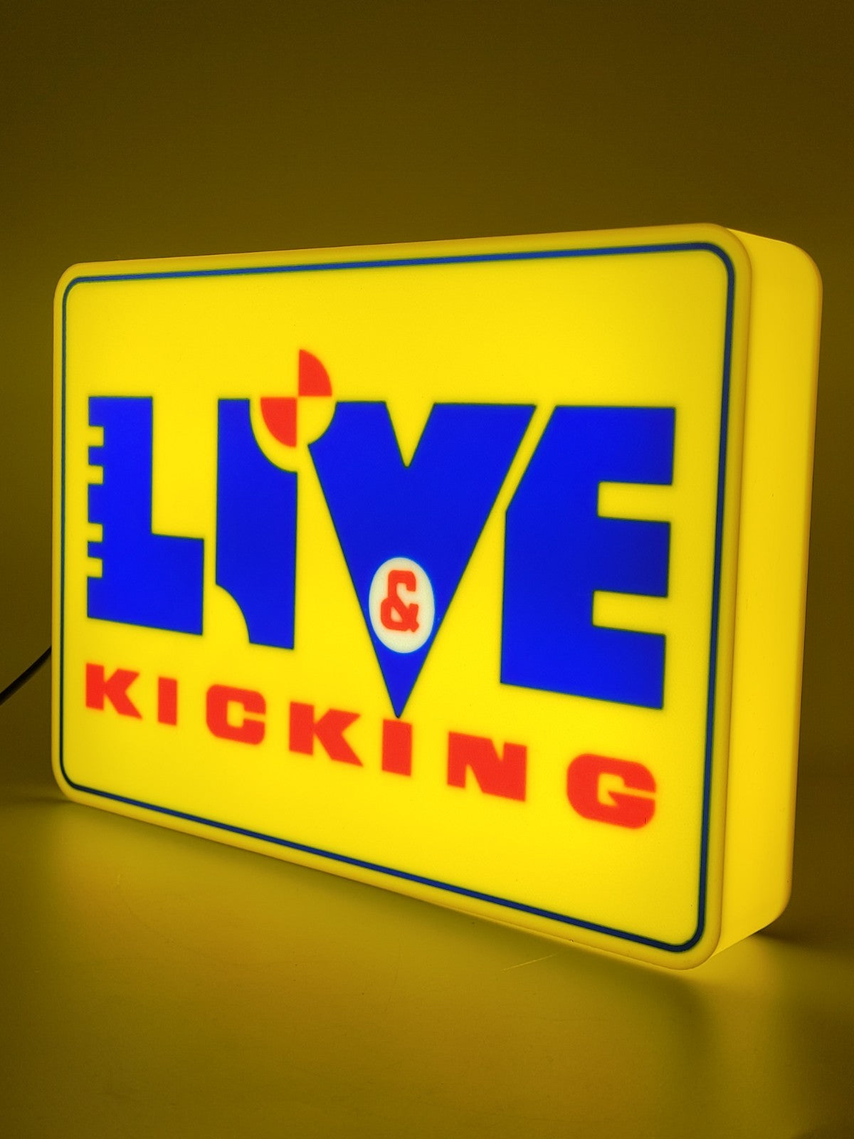 live and kicking led light sign with illuminated logo viewed from side view