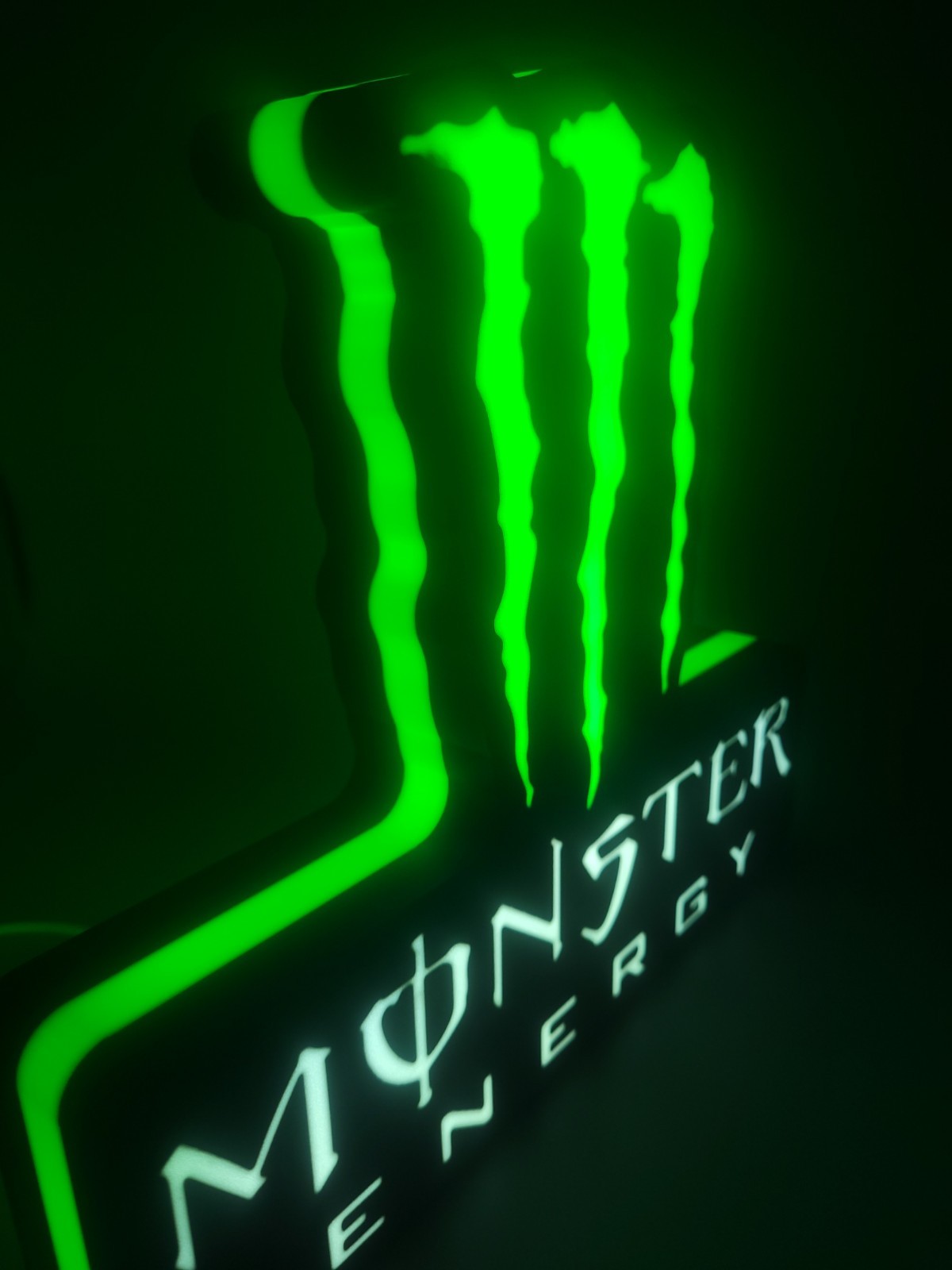 monster LED light sign with illuminated logo viewed from side view
