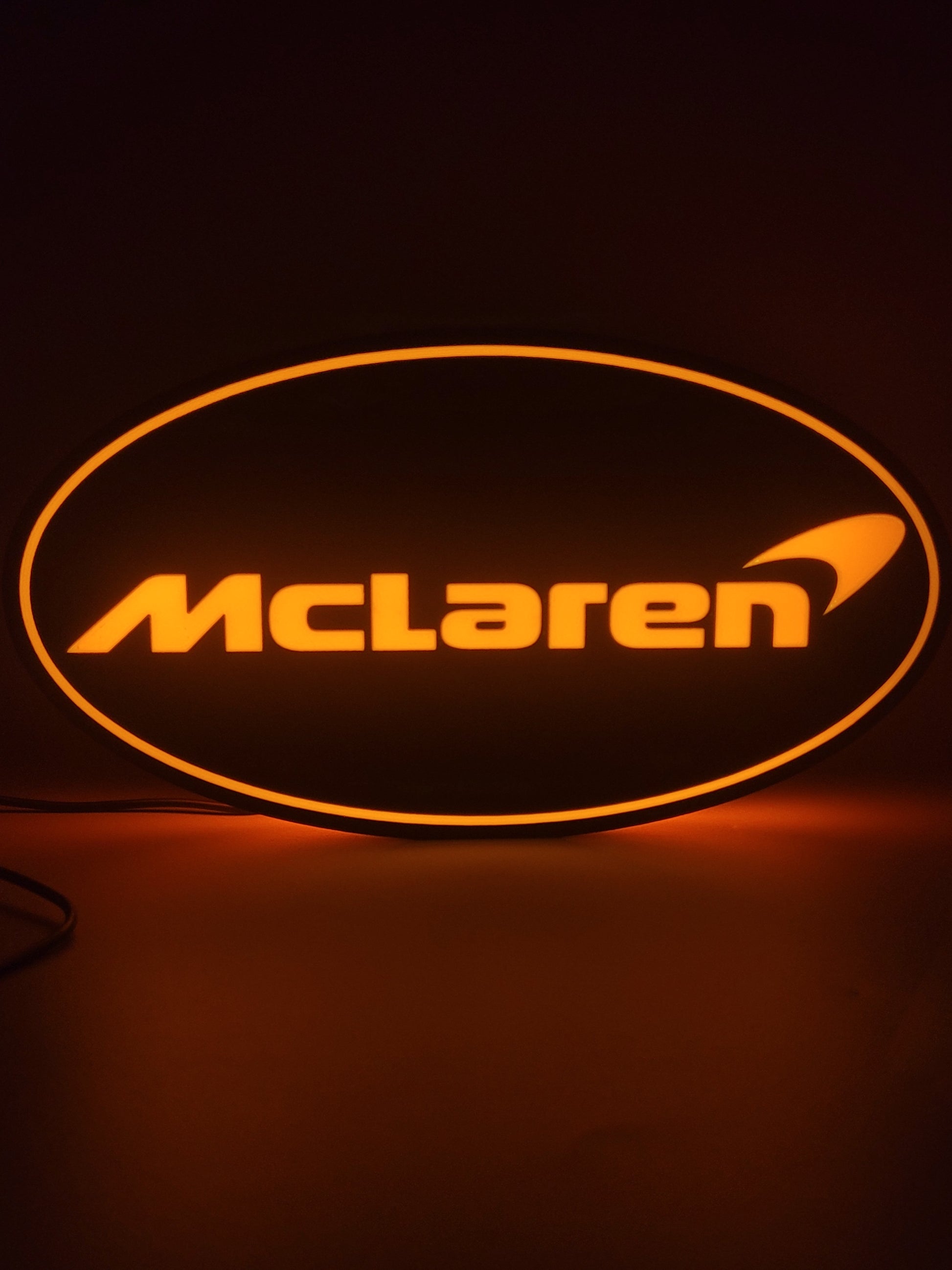 Mclaren LED light sign with illuminated logo viewed from straight on
