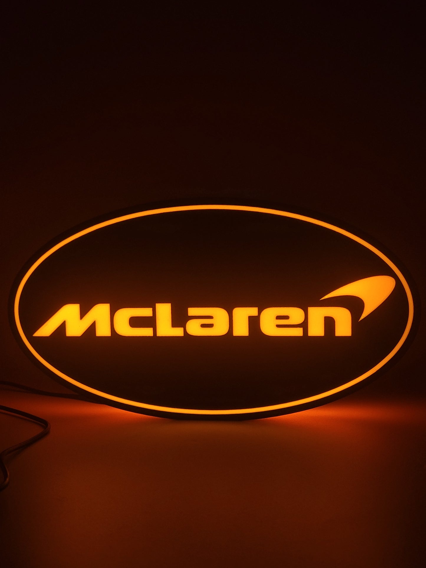 Mclaren LED light sign with illuminated logo viewed from straight on