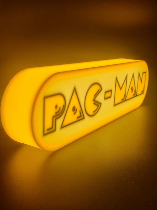 Pac-Man LED light sign with illuminated logo viewed from side view