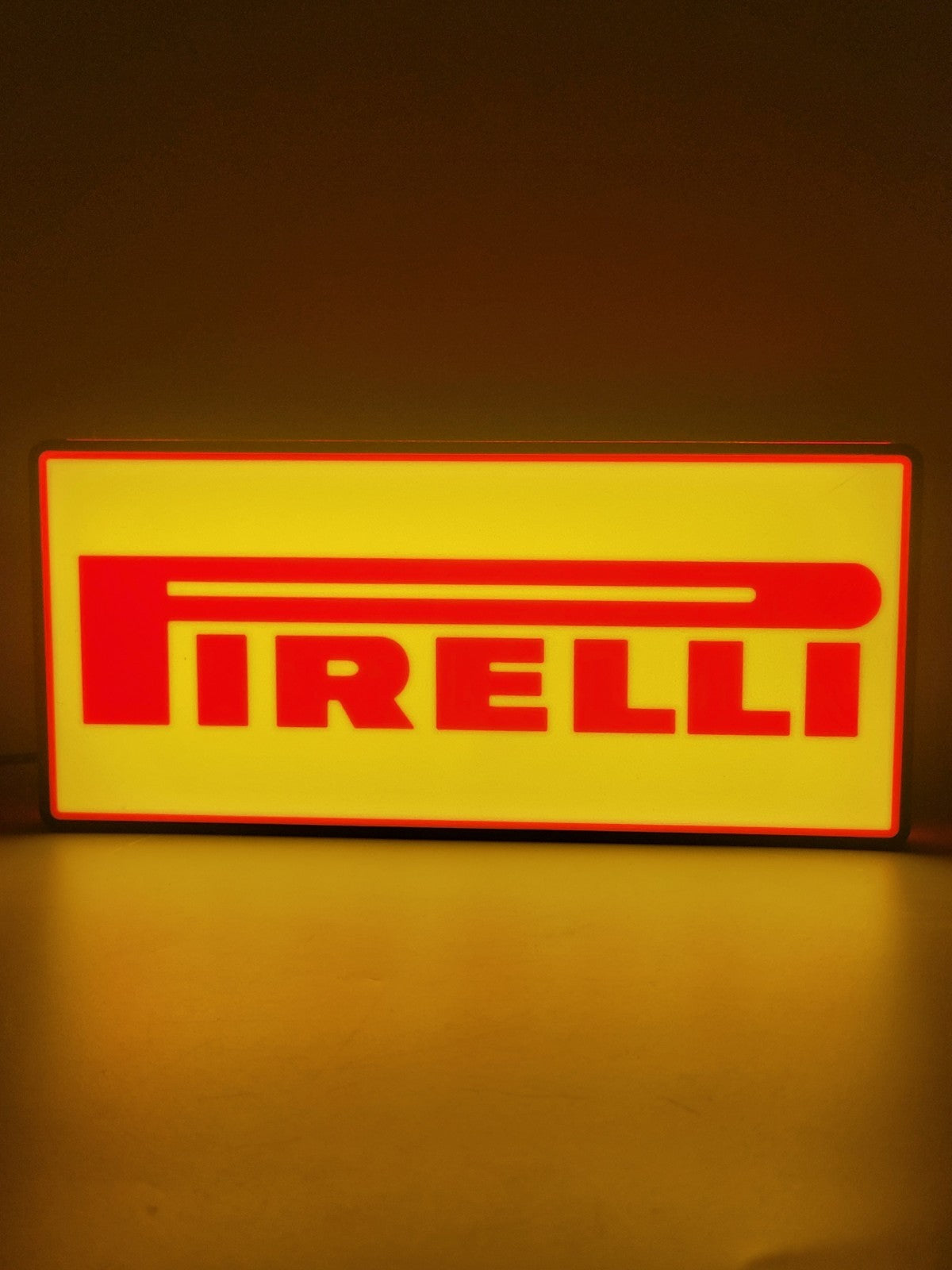 Pirelli LED light sign with illuminated logo viewed from straight on