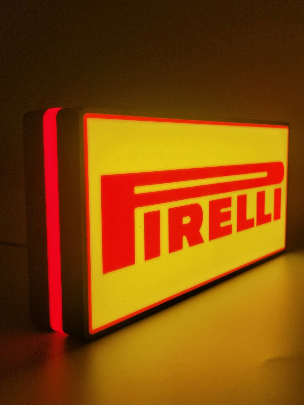 Pirelli LED light sign with illuminated logo viewed from side view